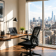 Modern home office with standing desk, laptop, and floor-to-ceiling windows overlooking a city skyline